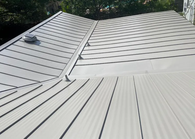 Solar attic fan installed on a metal roof for Roof Ventilation in Amityville